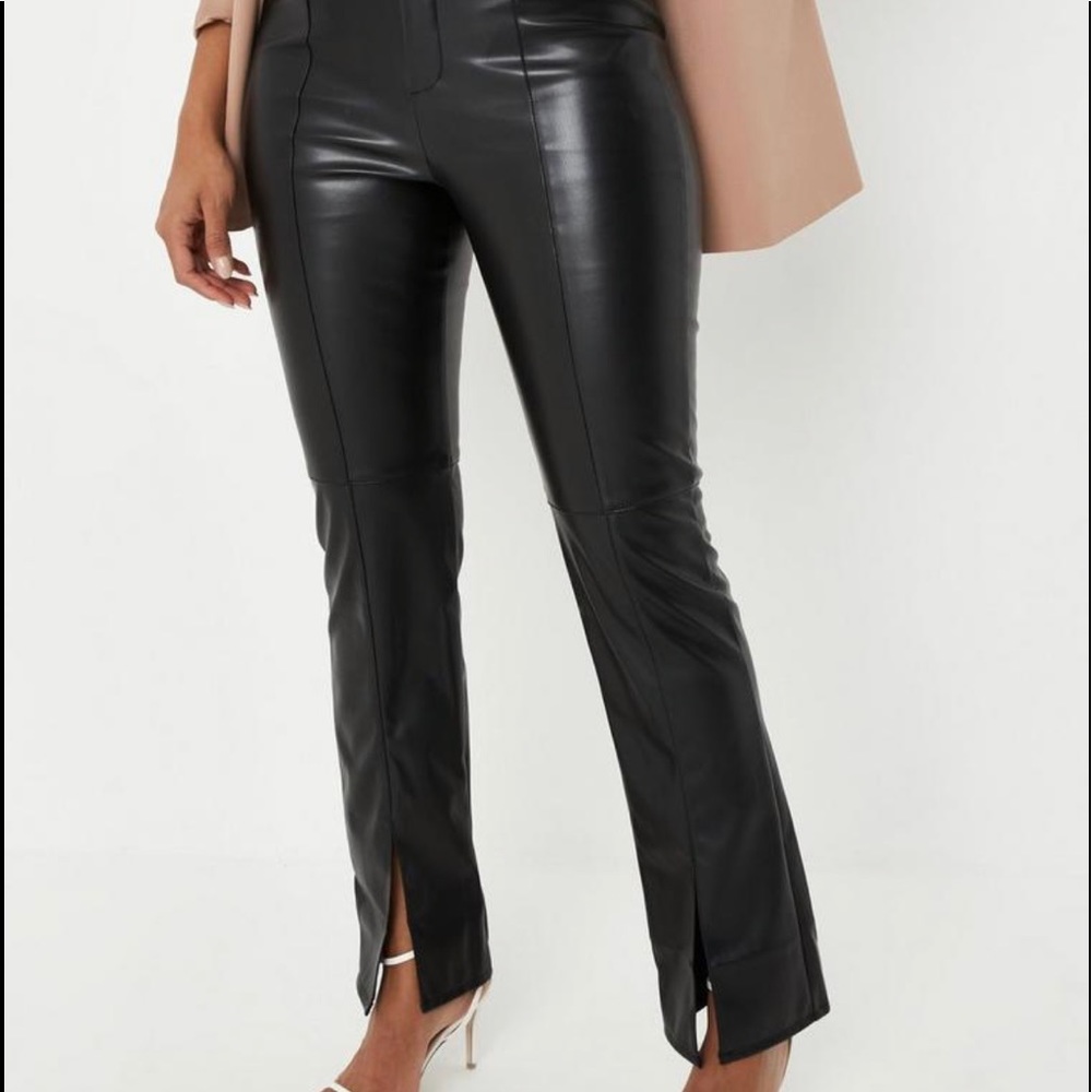 high waisted faux leather featuring a zip and button front and split hem detail